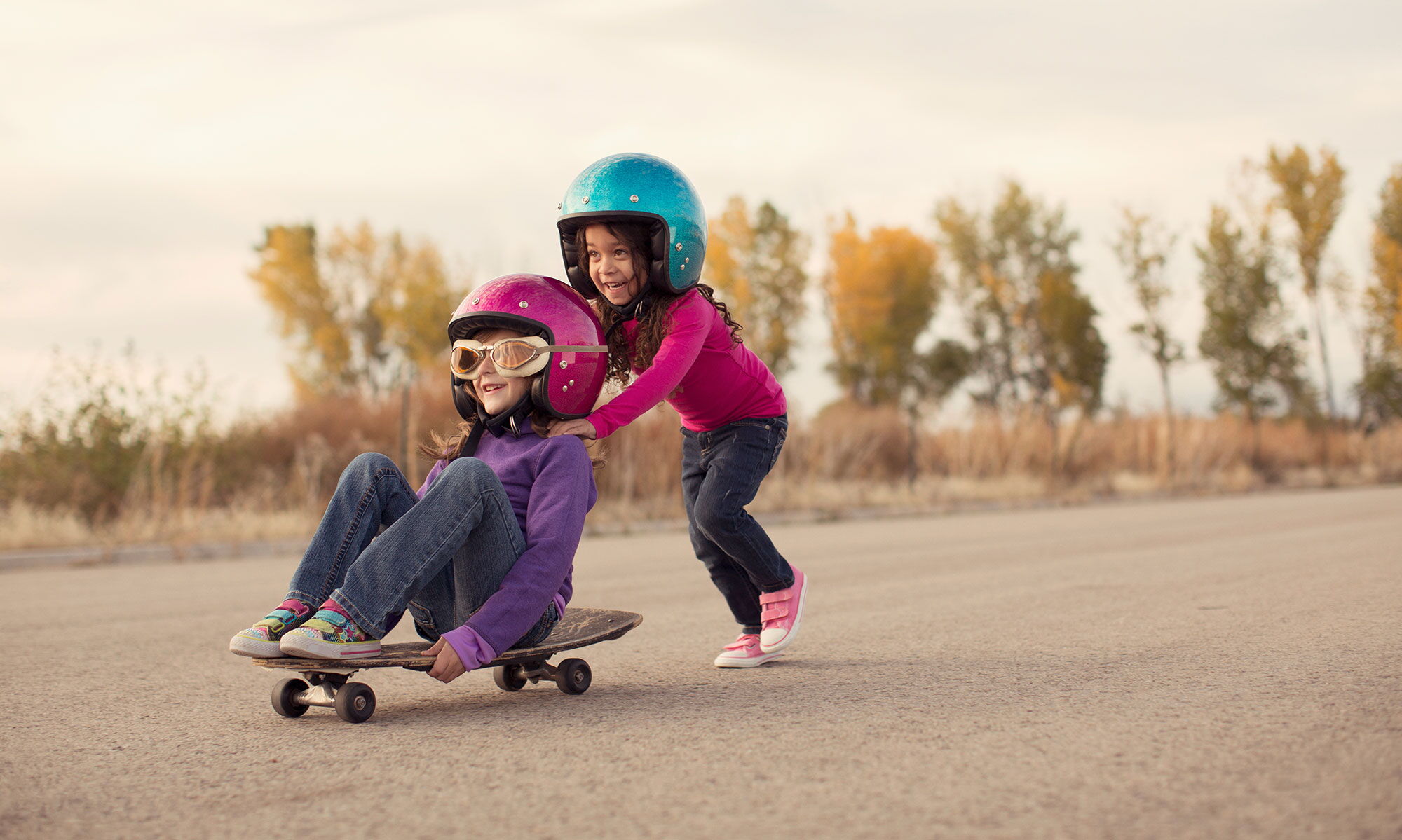 Friends playing with skateboard